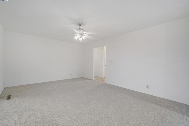 empty room featuring light colored carpet and ceiling fan