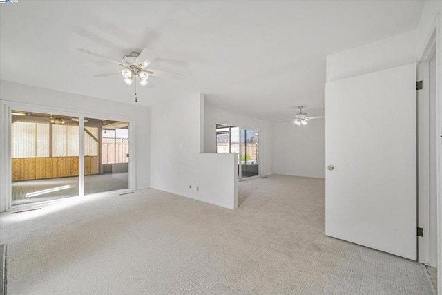 empty room featuring light carpet and ceiling fan