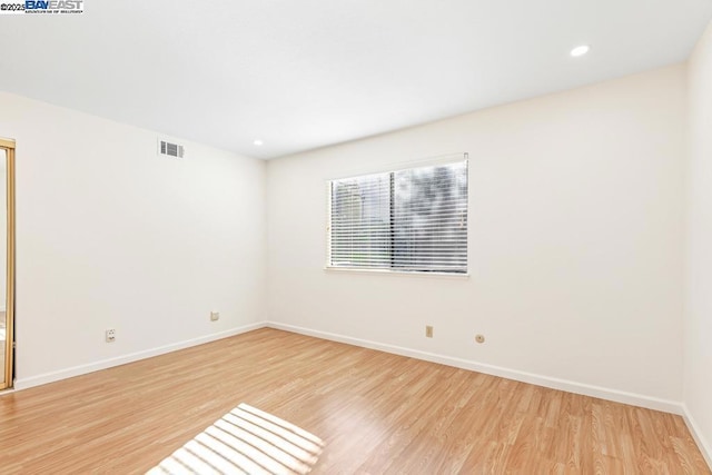 unfurnished room with light hardwood / wood-style floors