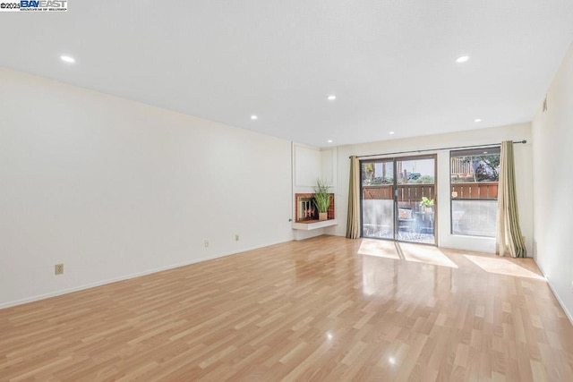 unfurnished living room featuring light wood-type flooring