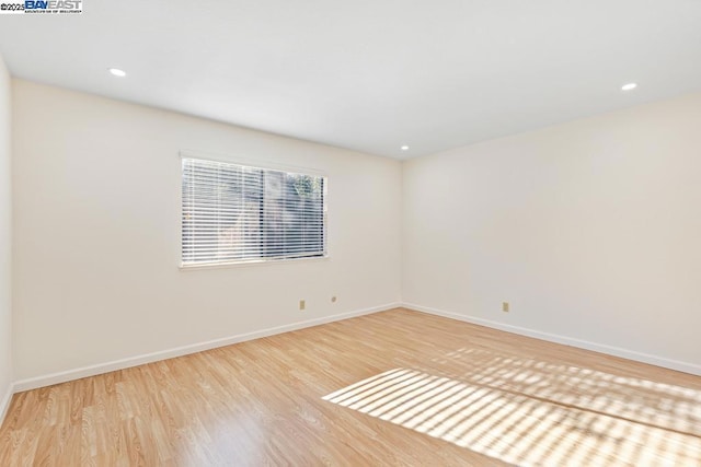 unfurnished room featuring light hardwood / wood-style floors