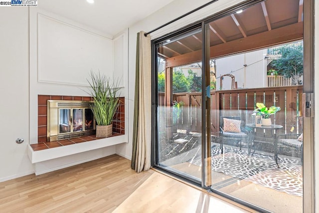 doorway featuring hardwood / wood-style flooring and a fireplace