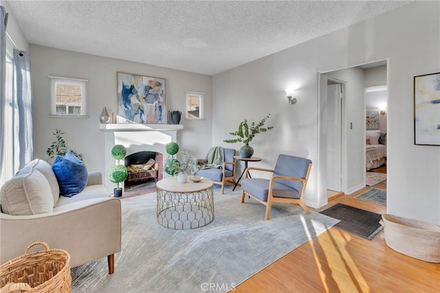 living room with hardwood / wood-style floors and a textured ceiling