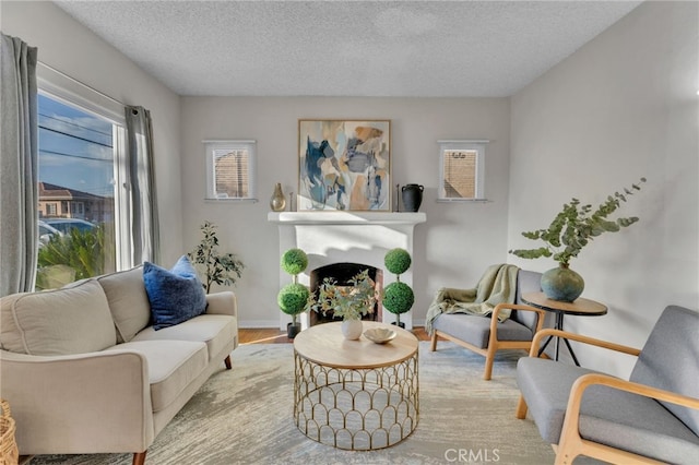 sitting room with light wood-type flooring and a textured ceiling