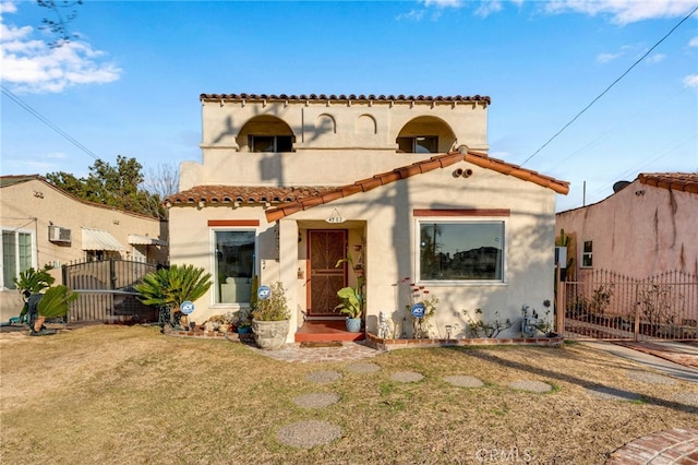 mediterranean / spanish-style house featuring a front lawn