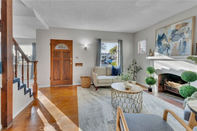 living room featuring light hardwood / wood-style floors and a textured ceiling