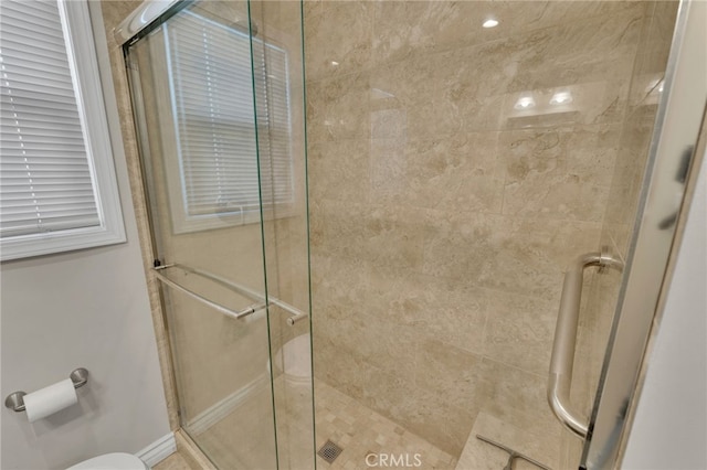 bathroom with a shower with shower door