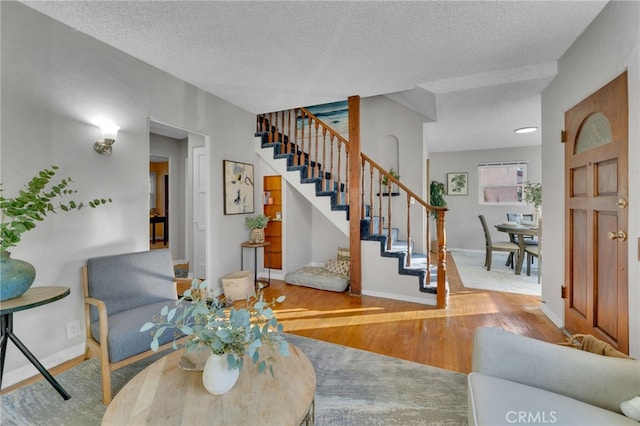 living room with hardwood / wood-style floors and a textured ceiling