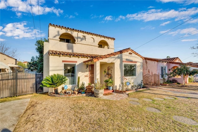 mediterranean / spanish-style home featuring a front lawn