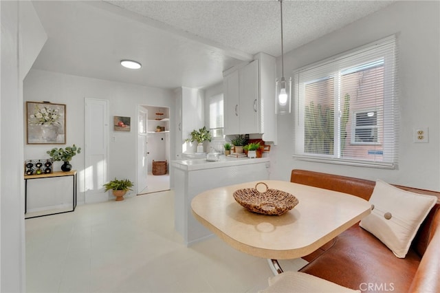 dining area featuring breakfast area and a textured ceiling