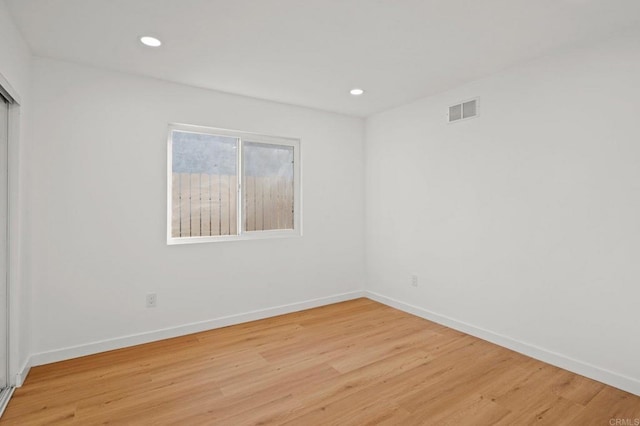 spare room featuring light wood-type flooring