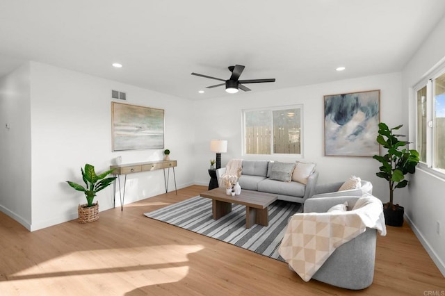 living room featuring ceiling fan and light wood-type flooring