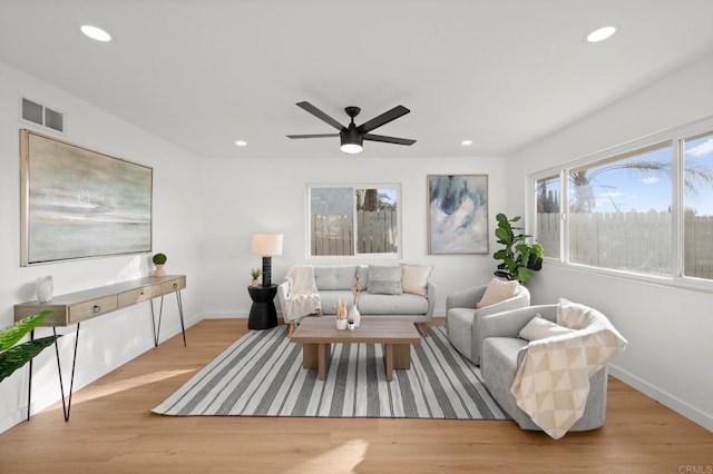 living room with ceiling fan and light hardwood / wood-style floors