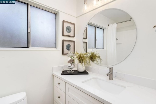 bathroom featuring vanity and toilet