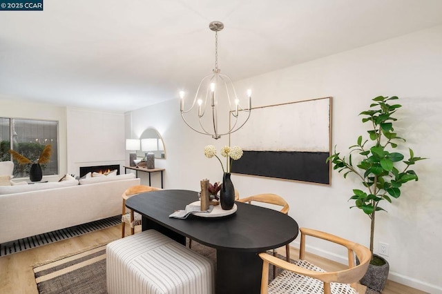 dining room with hardwood / wood-style floors and a notable chandelier