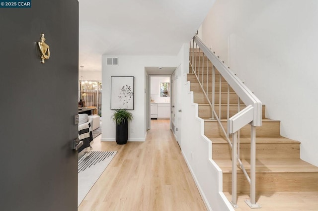 interior space with hardwood / wood-style flooring and a chandelier