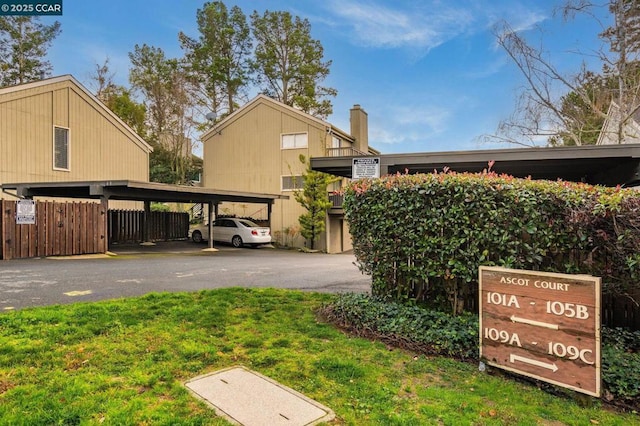 exterior space featuring a lawn and a carport