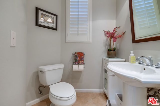 bathroom with sink, tile patterned floors, and toilet