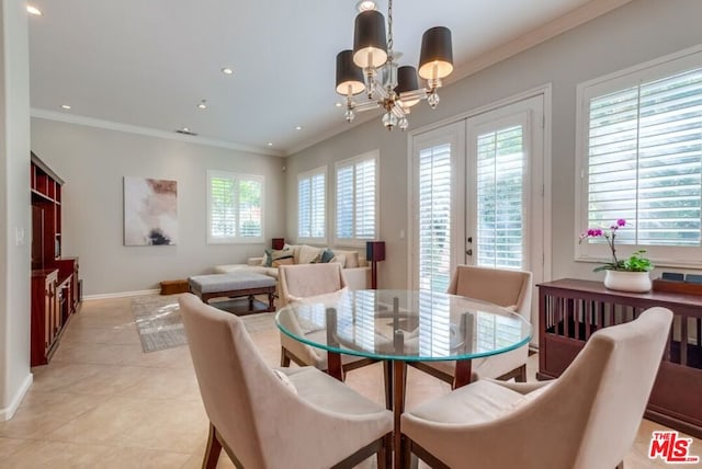 dining area with ornamental molding, light tile patterned flooring, and an inviting chandelier