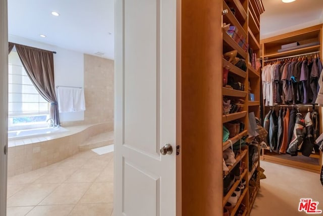 spacious closet with light tile patterned floors