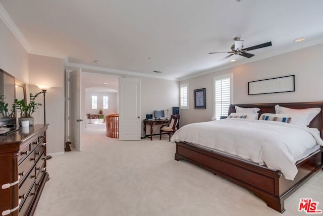 bedroom featuring ornamental molding, light carpet, and ceiling fan