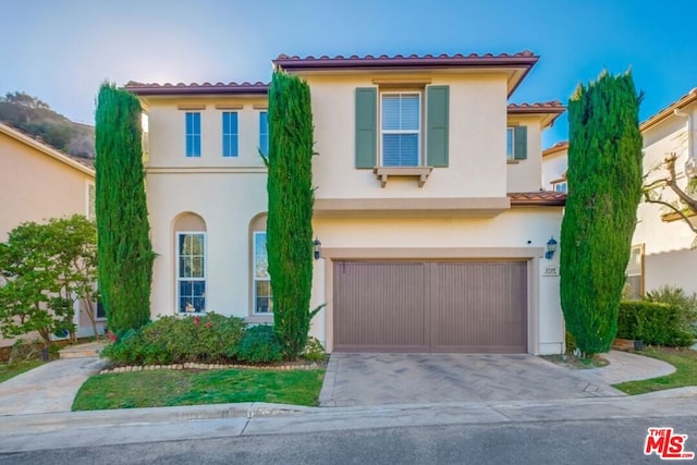 mediterranean / spanish-style house with a garage