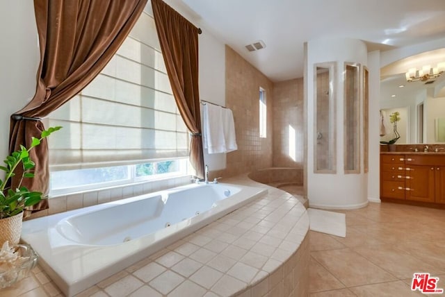 bathroom with tile patterned flooring, vanity, and plus walk in shower