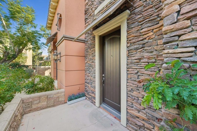 property entrance with a patio