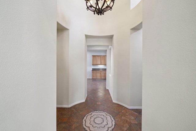 hallway featuring an inviting chandelier