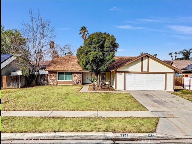 single story home with driveway, a garage, fence, and a front yard