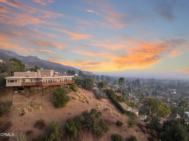 aerial view at dusk featuring a mountain view