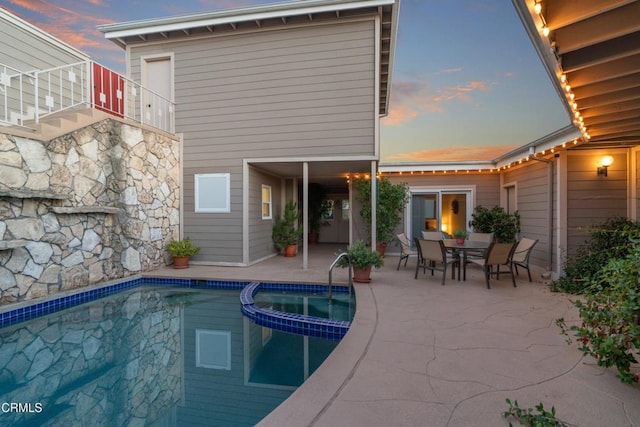 view of swimming pool with a patio area and a pool with connected hot tub