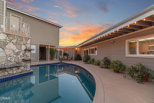 view of swimming pool with a pool with connected hot tub and a patio