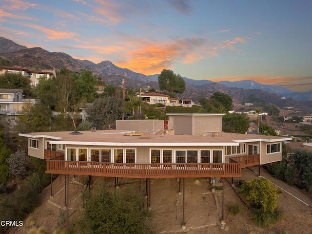 back of house featuring a deck with mountain view