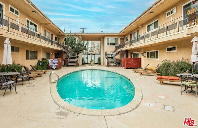 view of swimming pool with a patio