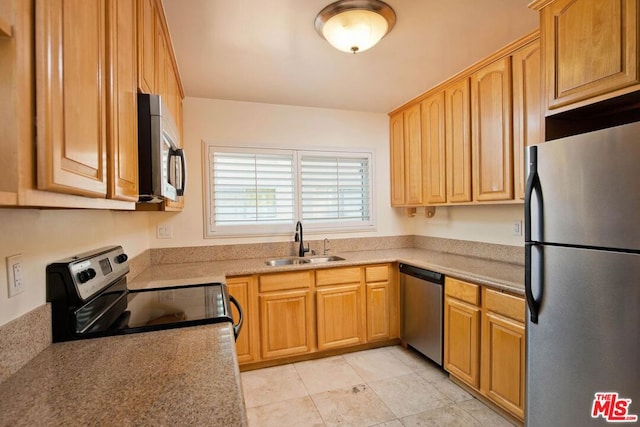 kitchen with light tile patterned flooring, stainless steel appliances, and sink