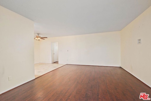 spare room with hardwood / wood-style flooring and ceiling fan