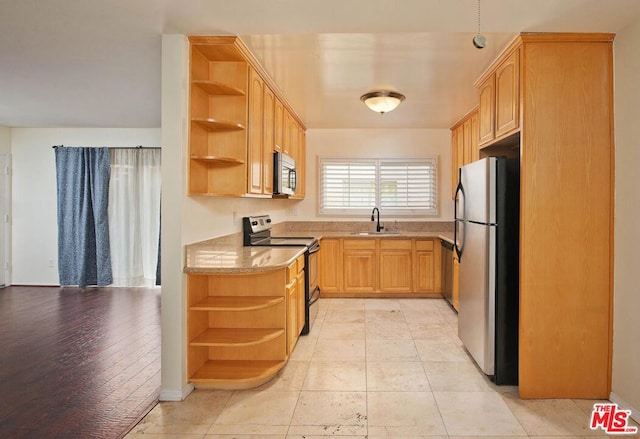 kitchen with light tile patterned flooring, appliances with stainless steel finishes, sink, and light brown cabinetry