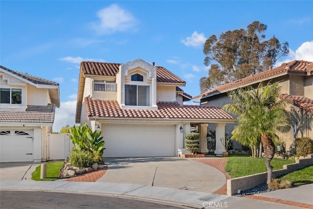 mediterranean / spanish house with a garage