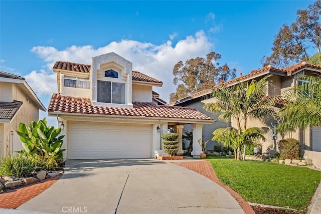 mediterranean / spanish house with a garage and a front lawn