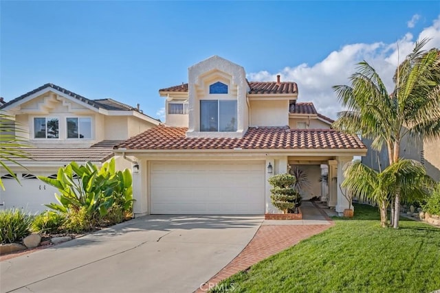 mediterranean / spanish house featuring a garage and a front yard