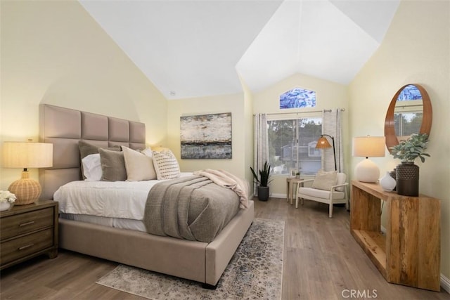 bedroom with hardwood / wood-style flooring and vaulted ceiling