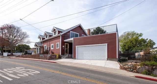 view of front of house with a garage and a balcony