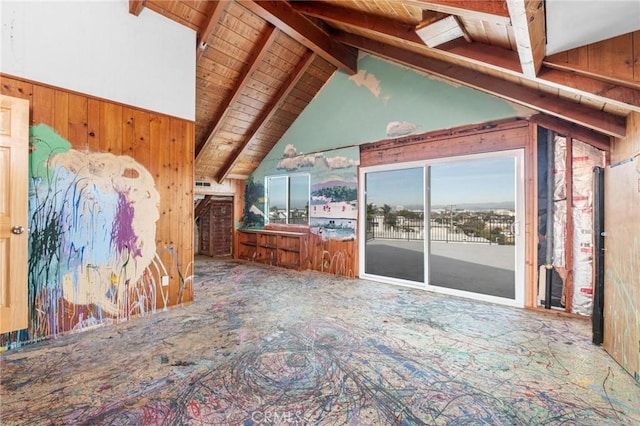 unfurnished living room with wood ceiling, wooden walls, and lofted ceiling with beams