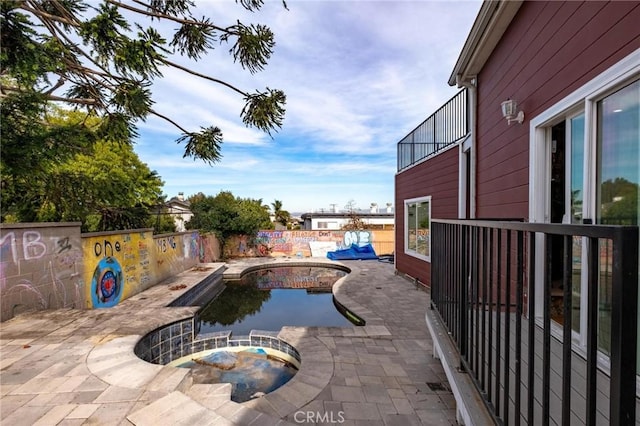 view of swimming pool featuring an in ground hot tub and a patio area