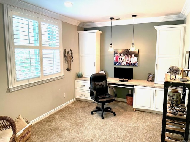 home office featuring baseboards, built in study area, light colored carpet, and crown molding