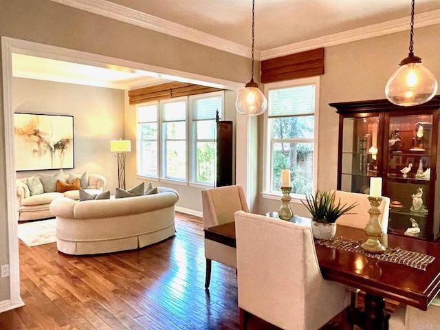 dining room featuring ornamental molding, wood finished floors, and baseboards