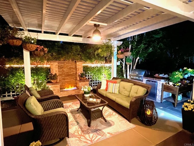 view of patio featuring area for grilling and an outdoor living space with a fireplace