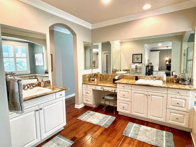 full bath with hardwood / wood-style floors, a sink, and crown molding