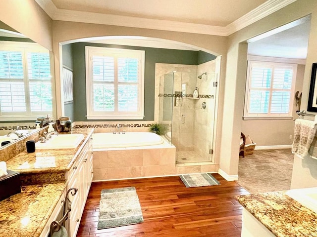 full bathroom with crown molding, vanity, a shower stall, wood finished floors, and a bath